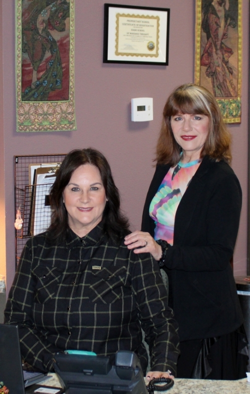 Students at front desk of massage school